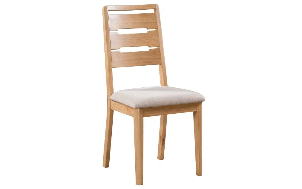Enhance your dining space with the Elara Dining Chair, expertly crafted from solid oak for a blend of durability and natural beauty. Shop online today at www.nobleandnook.co.uk