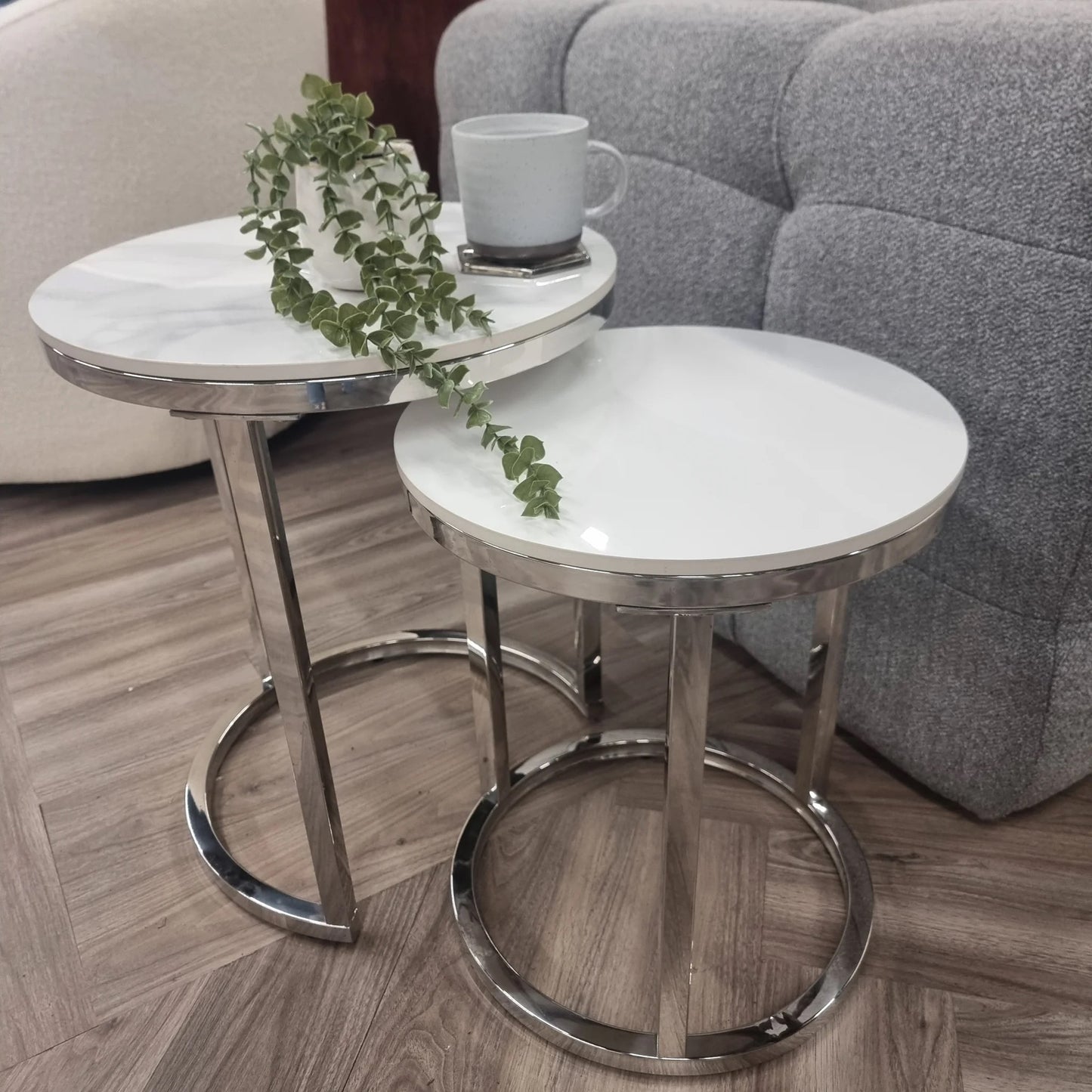 Shop the Calix Nest of 2 Tall End Tables, a stunning combination of modern elegance and practical design. Featuring Polar White sintered stone tops and sleek silver chrome frames. Shop online today at www.nobleandnook.co.uk
