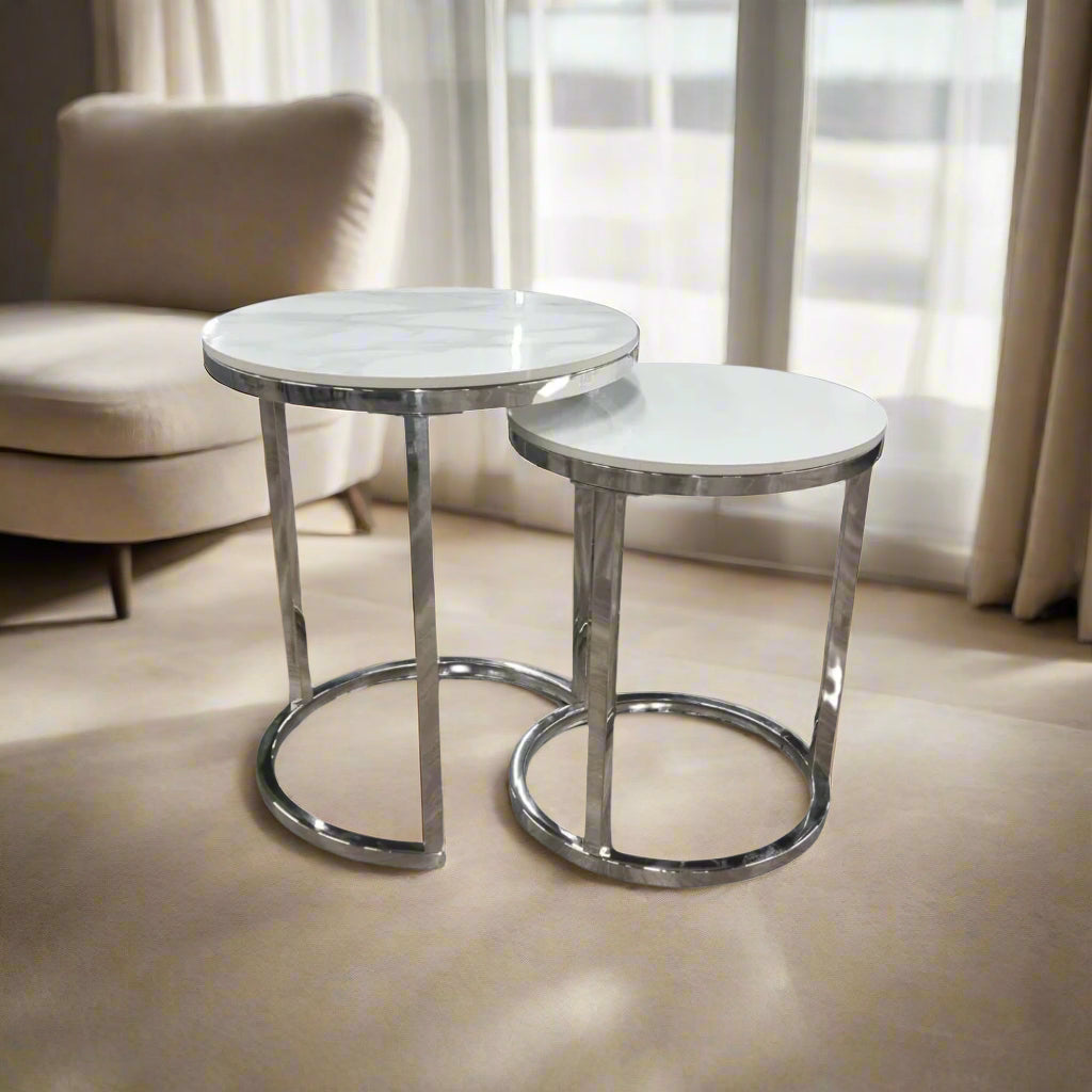 Shop the Calix Nest of 2 Tall End Tables, a stunning combination of modern elegance and practical design. Featuring Polar White sintered stone tops and sleek silver chrome frames. Shop online today at www.nobleandnook.co.uk