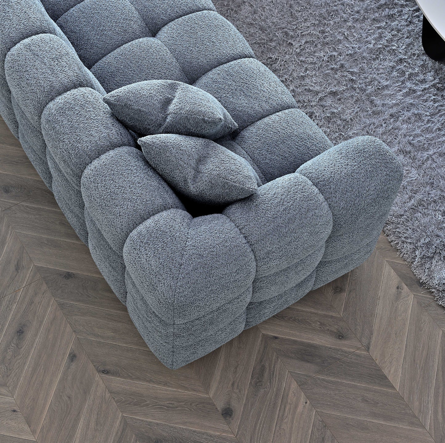 Shop the Tribeca Corner Sofa, featuring deep channel stitching and upholstered in a stunning iron boucle fabric. A modern twist on the classic Chesterfield design. Shop online today at www.nobleandnook.co.uk