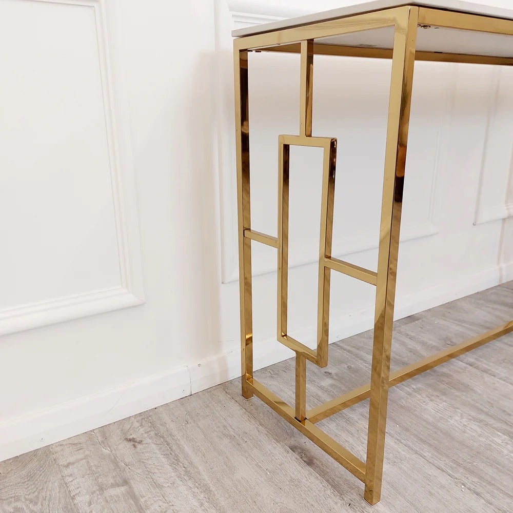 Add instant glamour to your home with this Console Table, featuring a bold, squared geometric frame in a radiant gold finish and a sleek Polar White Sintered Stone top. Shop online today at www.nobleandnook.co.uk