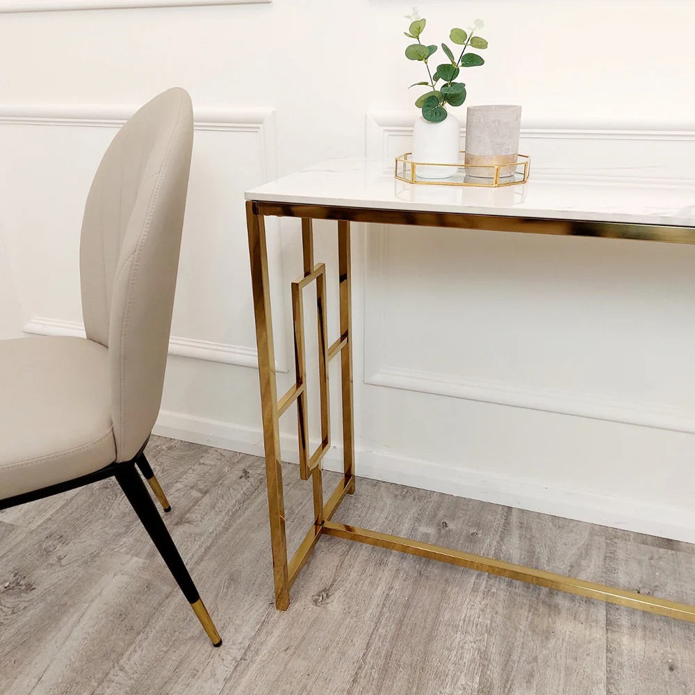 Add instant glamour to your home with this Console Table, featuring a bold, squared geometric frame in a radiant gold finish and a sleek Polar White Sintered Stone top. Shop online today at www.nobleandnook.co.uk