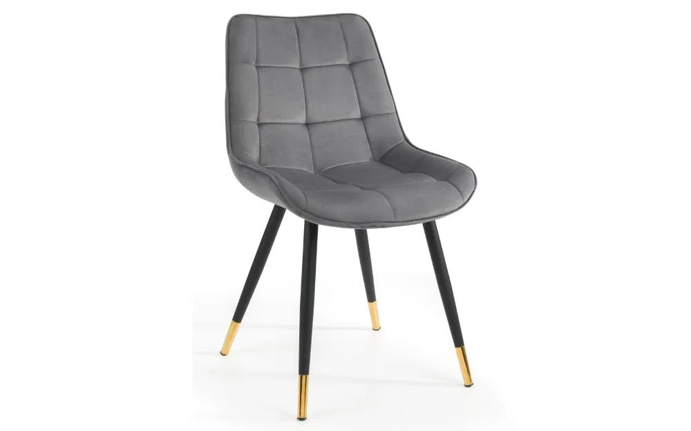 The Hadid Dining Chair brings sophistication to your space with its soft velvet upholstery and eye-catching black-and-gold leg design. Pair them with a sleek dining table. Shop online today at www.nobleandnook.co.uk