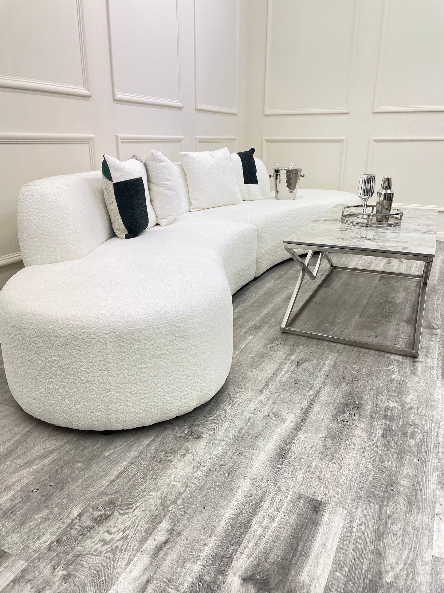 The Miami Curved Cinema Sofa, upholstered in soft and textured bouclé fabric. Perfect for a home games room or home cinema. Shop online today at www.nobleandnook.co.uk