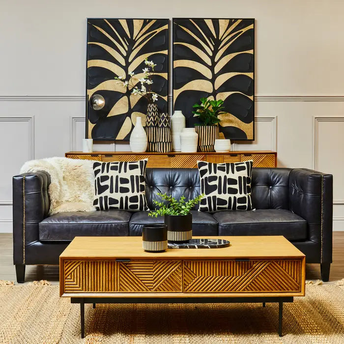 The Kajara Coffee Table pairs a natural carved wood finish with clean black metal legs, offering an elegant balance between rustic charm and modern minimalism. Shop online today at www.nobleandnook.co.uk