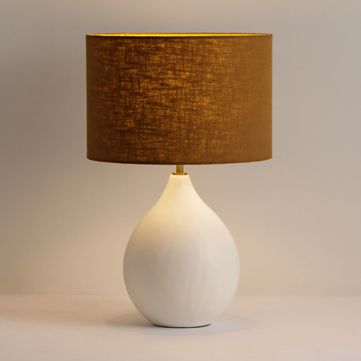 Shop the Small Round Gesso Lamp featuring a neutral taupe shade. A stylish piece that will add a touch of sophistication to any room. FREE UK MAINLAND DELIVERY. Shop online now at www.nobleandnook.co.uk