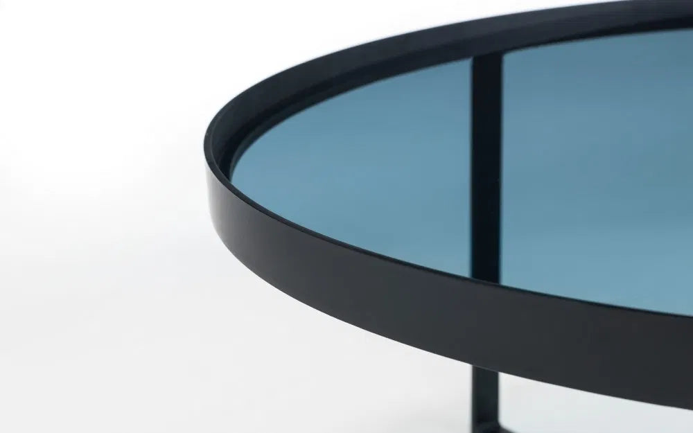 Shop the Soho Coffee Table, a perfect blend of sophistication, featuring a geometric black metal base and a smoked tempered glass top. Shop Online today at www.nobleandnook.co.uk