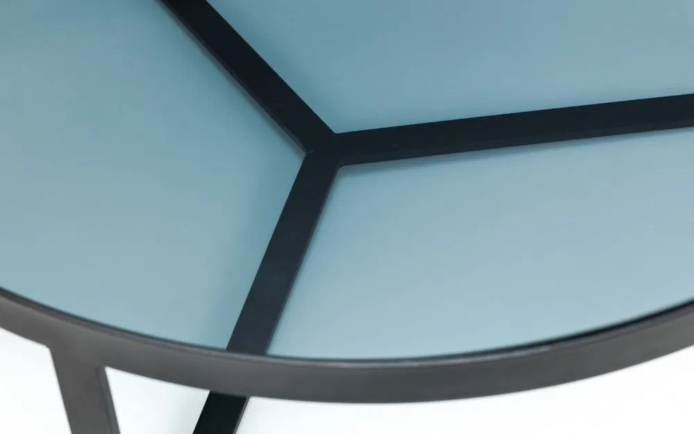 Shop the Soho Coffee Table, a perfect blend of sophistication, featuring a geometric black metal base and a smoked tempered glass top. Shop Online today at www.nobleandnook.co.uk