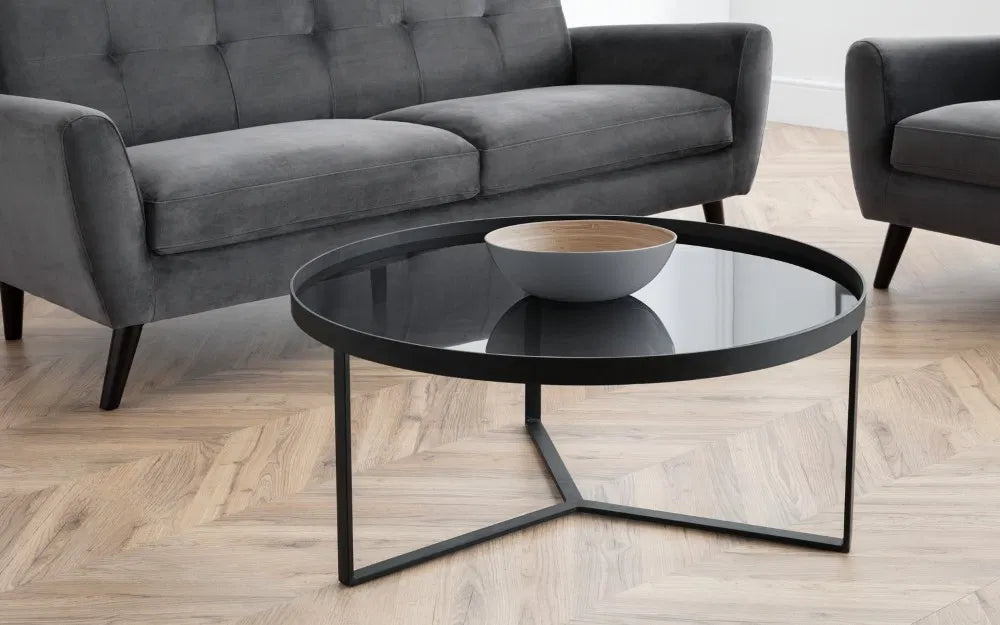 Shop the Soho Coffee Table, a perfect blend of sophistication, featuring a geometric black metal base and a smoked tempered glass top. Shop Online today at www.nobleandnook.co.uk