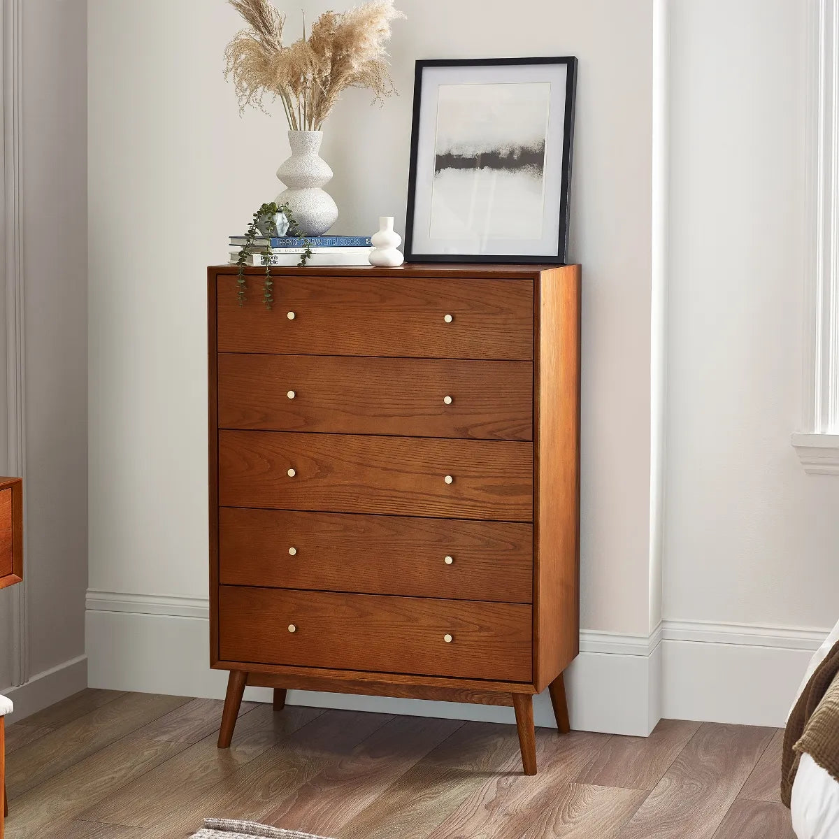 Shop the retro-inspired of the Lowry 5 Drawer Chest. A gorgeous timeless design in cherry ash wood veneer with gold handles. Shop online now at www.nobleandnook.co.uk