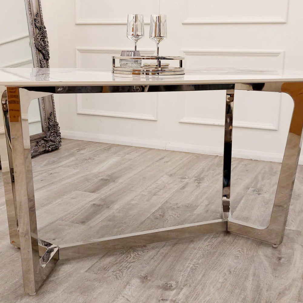 Shop the opulent Lucien Dining Table with Chrome base and luxurious Polar White Sintered Stone Top. At 160cm in length, it can comfortably accommodates 6 chairs. Shop online today at www.nobleandnook.co.uk