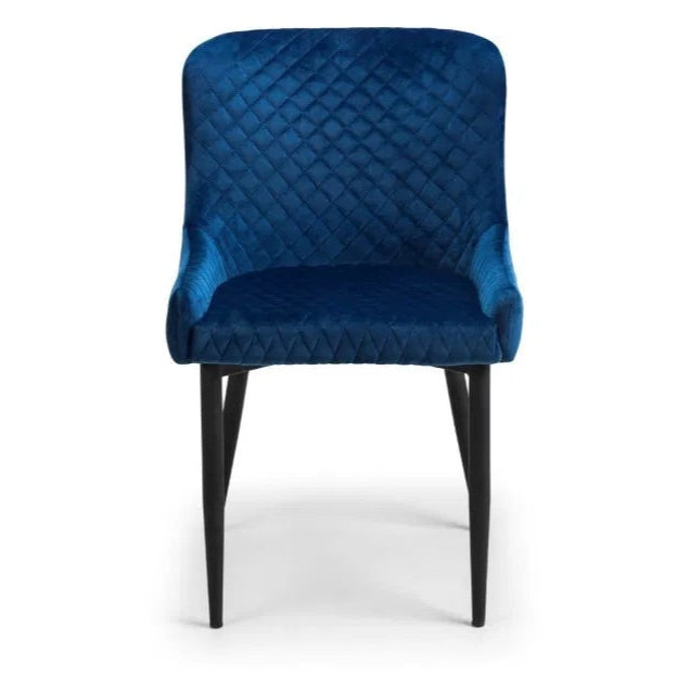 Add a sophisticated touch with the Luxe Blue Velvet Dining Chairs. Upholstered in rich blue velvet with intricate quilted detailing and black-painted legs. Shop online today at www.nobleandnook.co.uk