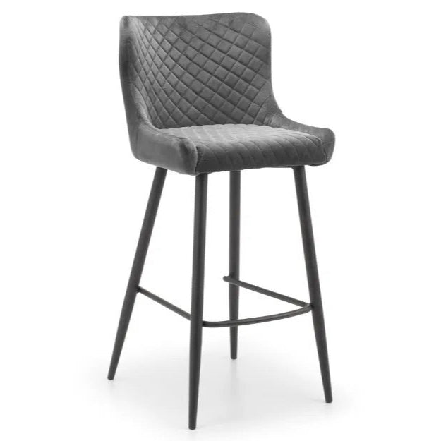 Bring a touch of luxury to your dining space with the Luxe Grey Velvet Bar Stool with sleek black metal legs. Ideal for kitchen islands, home bars, or high counters. Shop online today at www.nobleandnook.co.uk