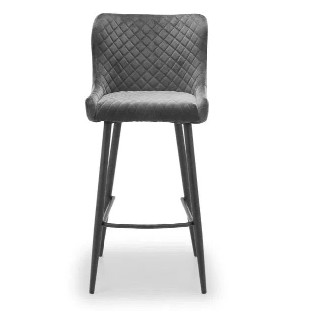 Bring a touch of luxury to your dining space with the Luxe Grey Velvet Bar Stool with sleek black metal legs. Ideal for kitchen islands, home bars, or high counters. Shop online today at www.nobleandnook.co.uk
