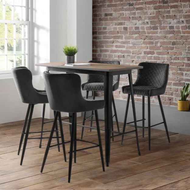 Bring a touch of luxury to your dining space with the Luxe Grey Velvet Bar Stool with sleek black metal legs. Ideal for kitchen islands, home bars, or high counters. Shop online today at www.nobleandnook.co.uk
