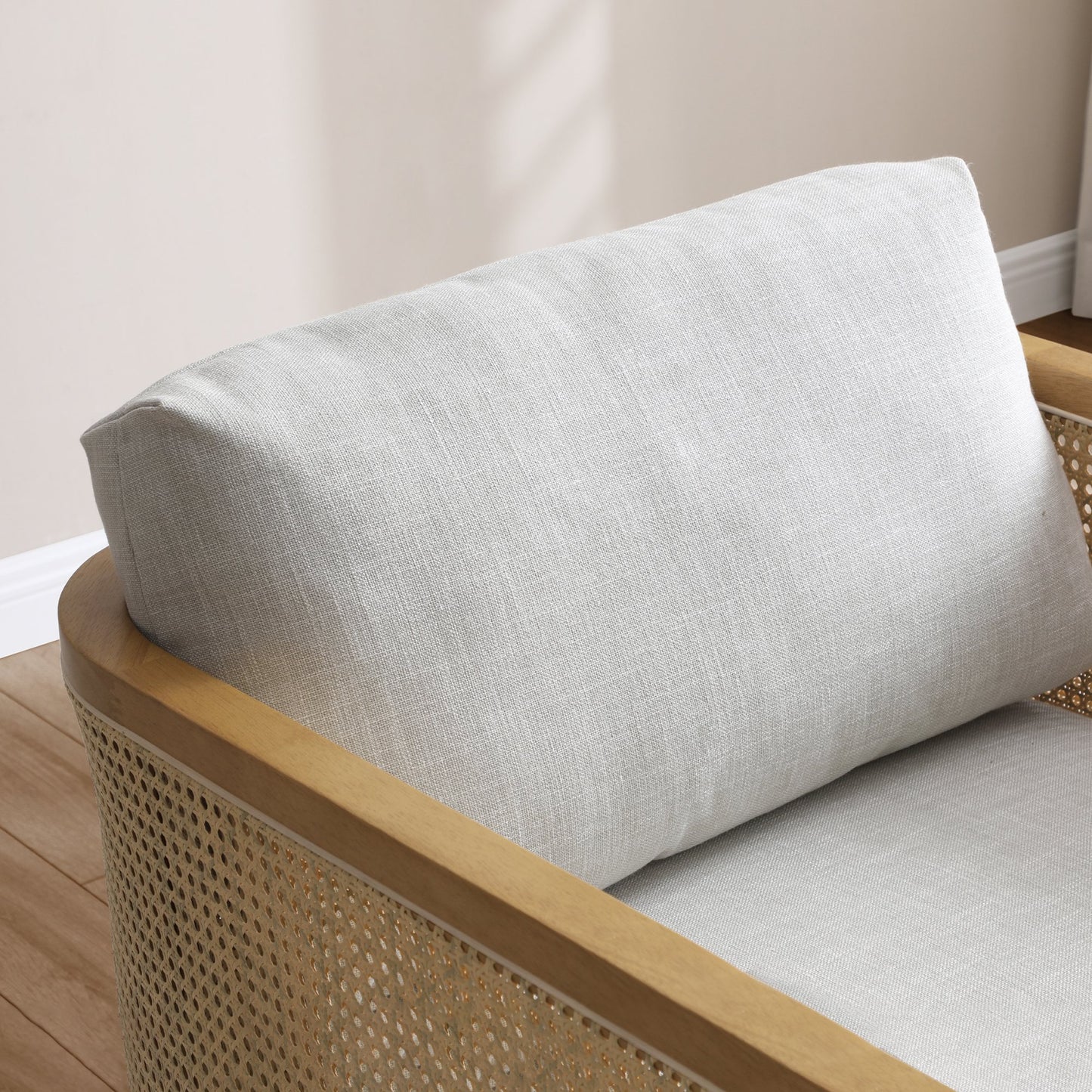 Shop the Mabel Rattan Accent Chair, a unique piece featuring a padded back and seat adorned with a bolster cushion, all resting on a stained wooden frame. Shop online now at www.nobleandnook.co.uk