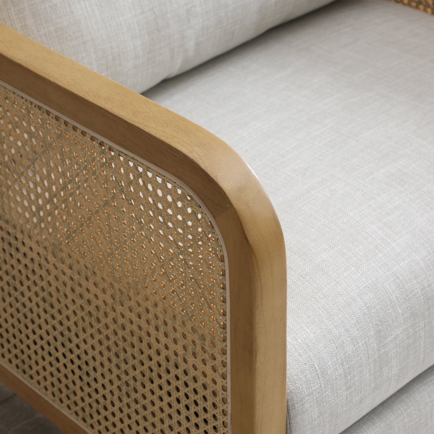 Shop the Mabel Rattan Accent Chair, a unique piece featuring a padded back and seat adorned with a bolster cushion, all resting on a stained wooden frame. Shop online now at www.nobleandnook.co.uk