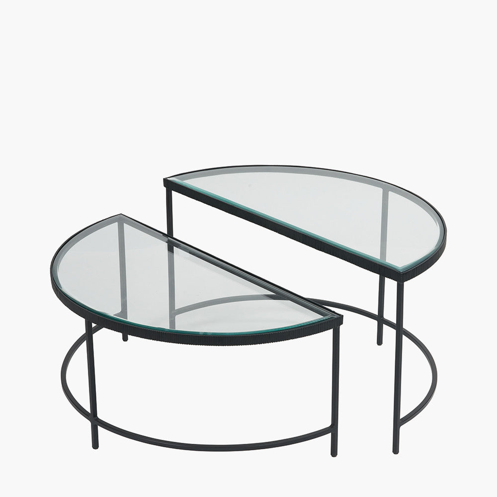 Shop the Marazzi Bevelled Glass & Black Metal Half Moon Coffee Tables, boasting a sleek black metal frame with elegant cast edging and clear, bevel-edged glass tops. Shop online now at www.nobleandnook.co.uk