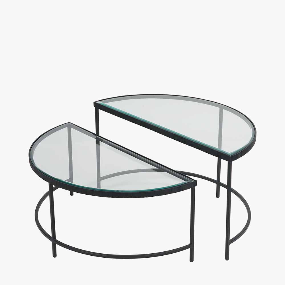 Shop the Marazzi Bevelled Glass & Black Metal Half Moon Coffee Tables, boasting a sleek black metal frame with elegant cast edging and clear, bevel-edged glass tops. Shop online now at www.nobleandnook.co.uk