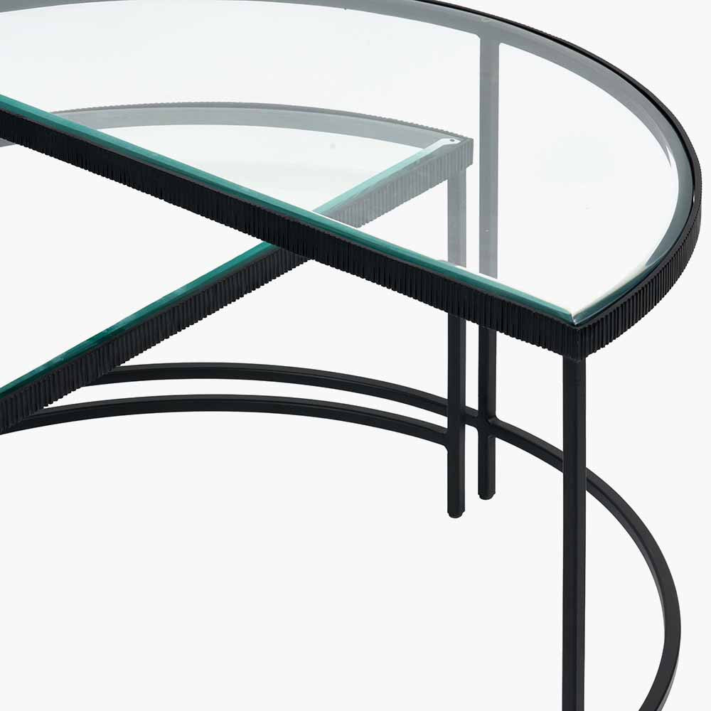 Shop the Marazzi Bevelled Glass & Black Metal Half Moon Coffee Tables, boasting a sleek black metal frame with elegant cast edging and clear, bevel-edged glass tops. Shop online now at www.nobleandnook.co.uk