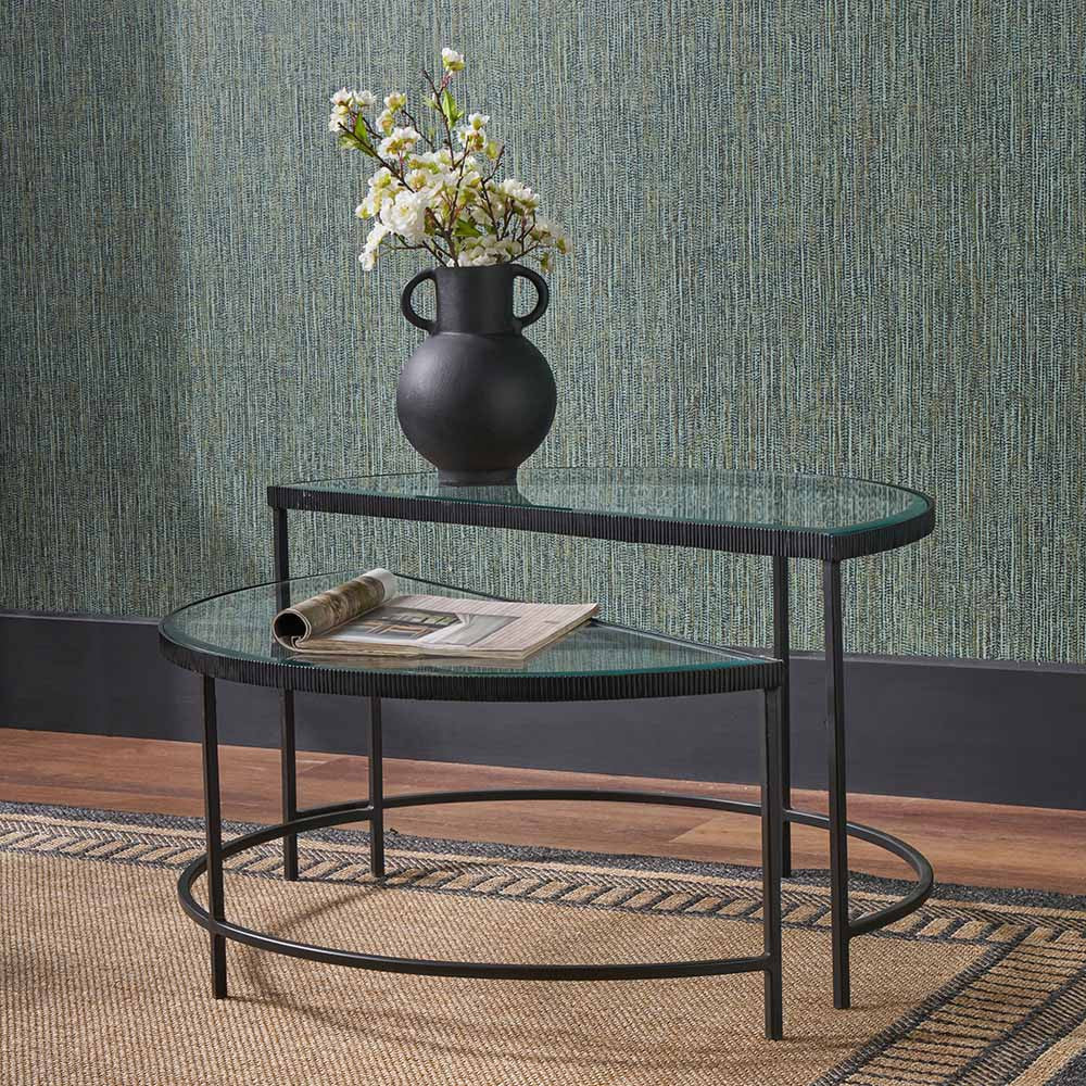 Shop the Marazzi Bevelled Glass & Black Metal Half Moon Coffee Tables, boasting a sleek black metal frame with elegant cast edging and clear, bevel-edged glass tops. Shop online now at www.nobleandnook.co.uk