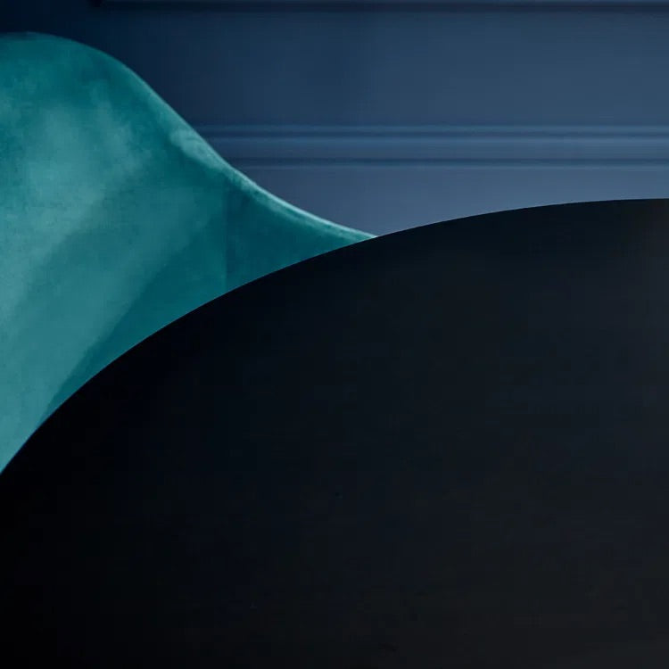 Gold geometric sculpture on a dark surface with a blue background