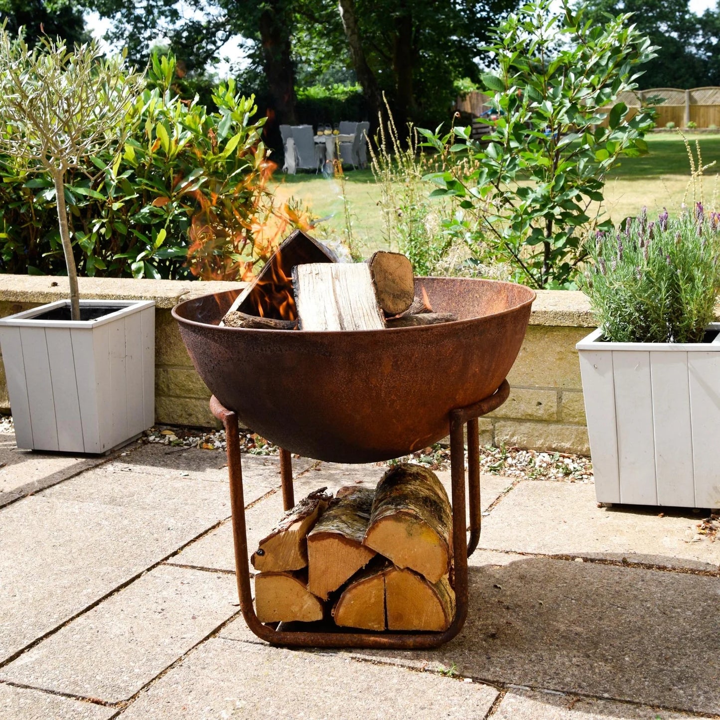 Extend your outdoor gatherings with this XL cast iron fire bowl with stand in Rust. Neatly elevated on a geometric stand, this rustic fire bowl brings instant warmth to your space, Shop online now at www.nobleandnook.co.uk