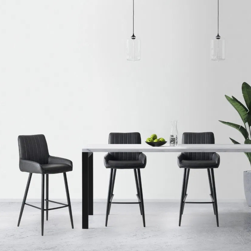Shop the Soho Black Faux Leather Barstool. Great for kitchen islands, home bars, or casual dining areas, this barstool delivers both function and flair. Shop online today at www.nobleandnook.co.uk