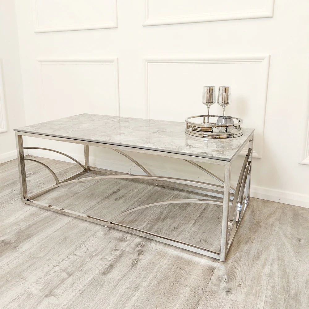 Shop today and enhance your living space with this Chrome Coffee Table, a perfect fusion of art deco inspired style and practicality, featuring a stunning marble effect Sintered Stone top. Shop online today at www.nobleandnook.co.uk