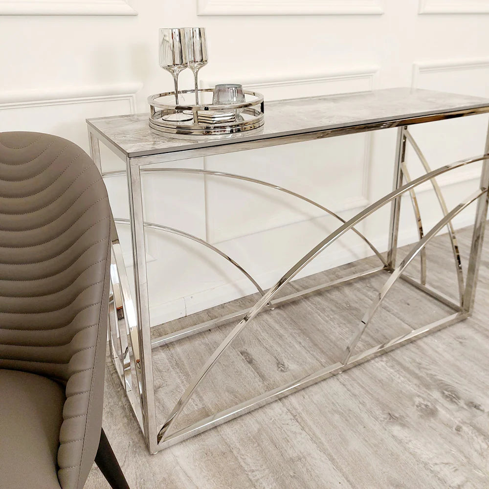 Shop now to define your interior design with this Chrome Framed art deco inspired Console Table, featuring a marble effect Sintered Stone top gold tone. Perfectly suited for hallways. Shop online today at www.nobleandnook.co.uk
