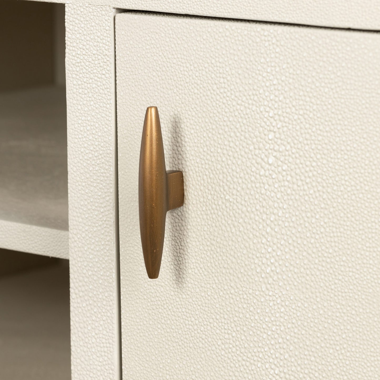 Introducing the Hampton TV Unit in luxurious Ivory shagreen, perfect for your TV and media needs. The elegant two-door design showcases brass style handles and base, while the fixed shelving offers ample space for all your entertainment essentials. Elevate your living space with this sophisticated and exclusive piece. Available at www.nobleandnook.co.uk