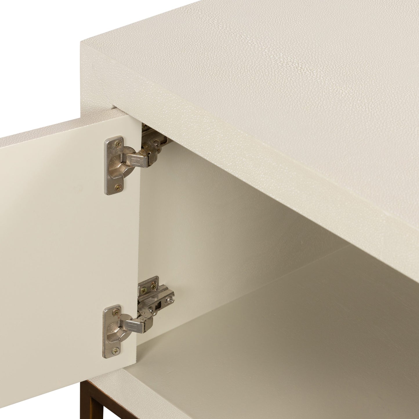 Introducing the Hampton TV Unit in luxurious Ivory shagreen, perfect for your TV and media needs. The elegant two-door design showcases brass style handles and base, while the fixed shelving offers ample space for all your entertainment essentials. Elevate your living space with this sophisticated and exclusive piece. Available at www.nobleandnook.co.uk