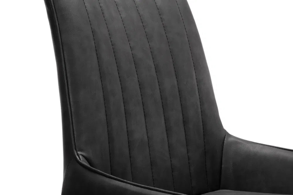 Shop these antique black faux leather dining chairs with sleek black metal frame for industrial edge. Retro styling with a modern twist – ideal for urban interiors. Shop online today at www.nobleandnook.co.uk