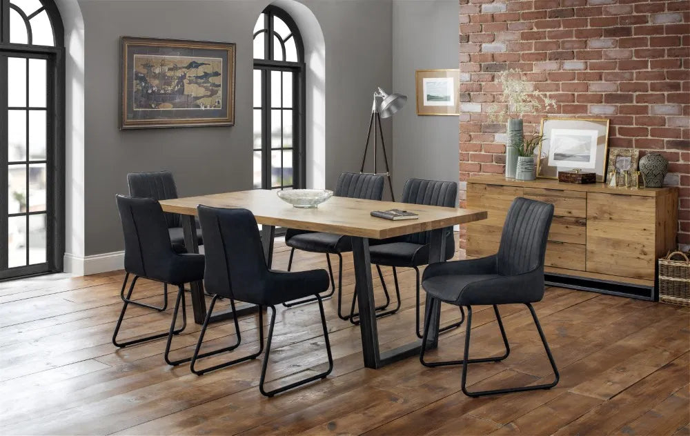 Shop these antique black faux leather dining chairs with sleek black metal frame for industrial edge. Retro styling with a modern twist – ideal for urban interiors. Shop online today at www.nobleandnook.co.uk