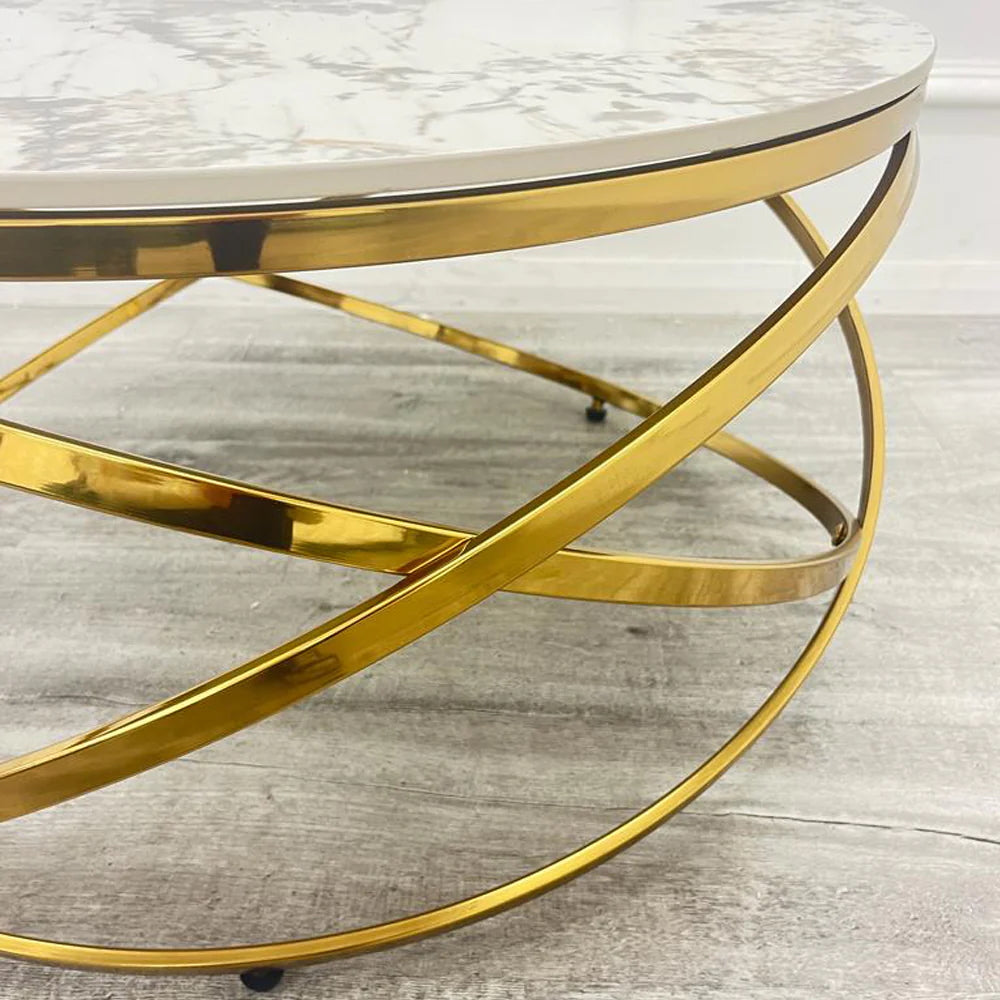 Adding a touch of modern luxury to your living space, the Spiro Round Coffee Table features a sleek design with a Pandora sintered stone top and an intricate gold metal frame. Shop online today at www.nobleandnook.co.uk