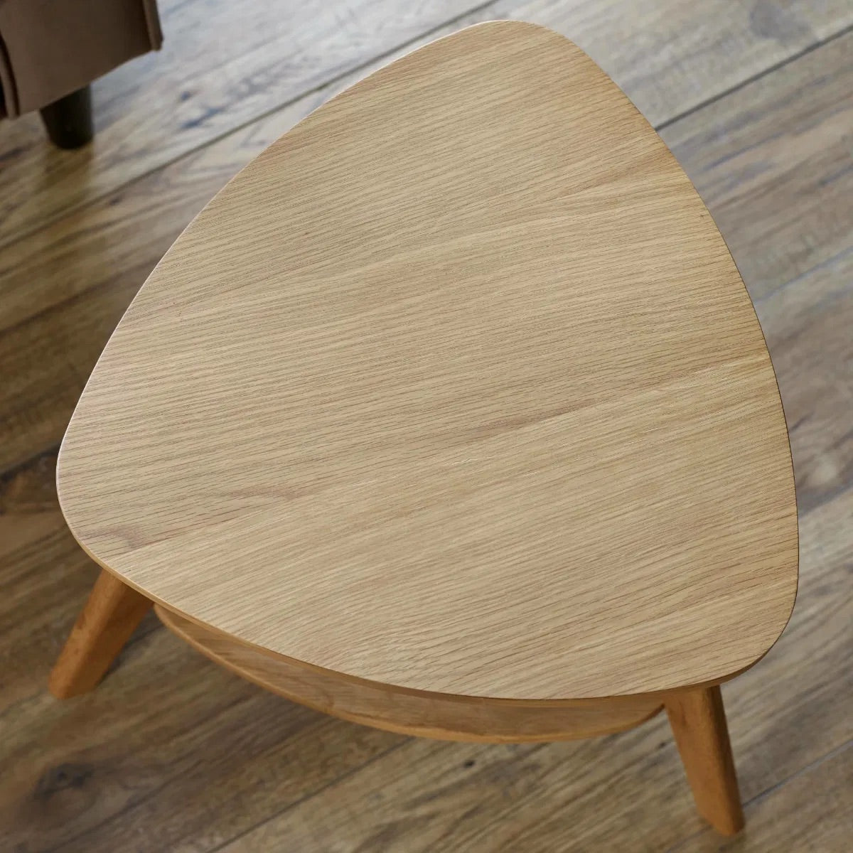 The Vera Side three-legged Table, featuring a rattan-inspired shelf and a warm natural wood finish. Perfect for smaller spaces. Available at www.nobleandnook.co.uk