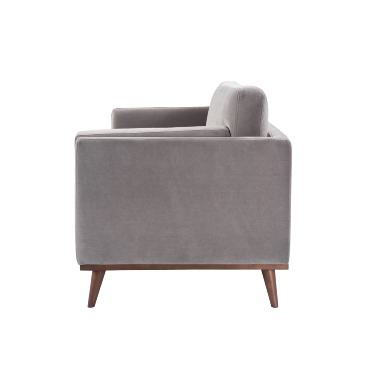 Shop the Mickey 3 Seat Sofa in a fashionable grey velvet hue with tapered walnut legs. This is a contemporary masterpiece. Shop online today at www.nobleandnook.co.uk