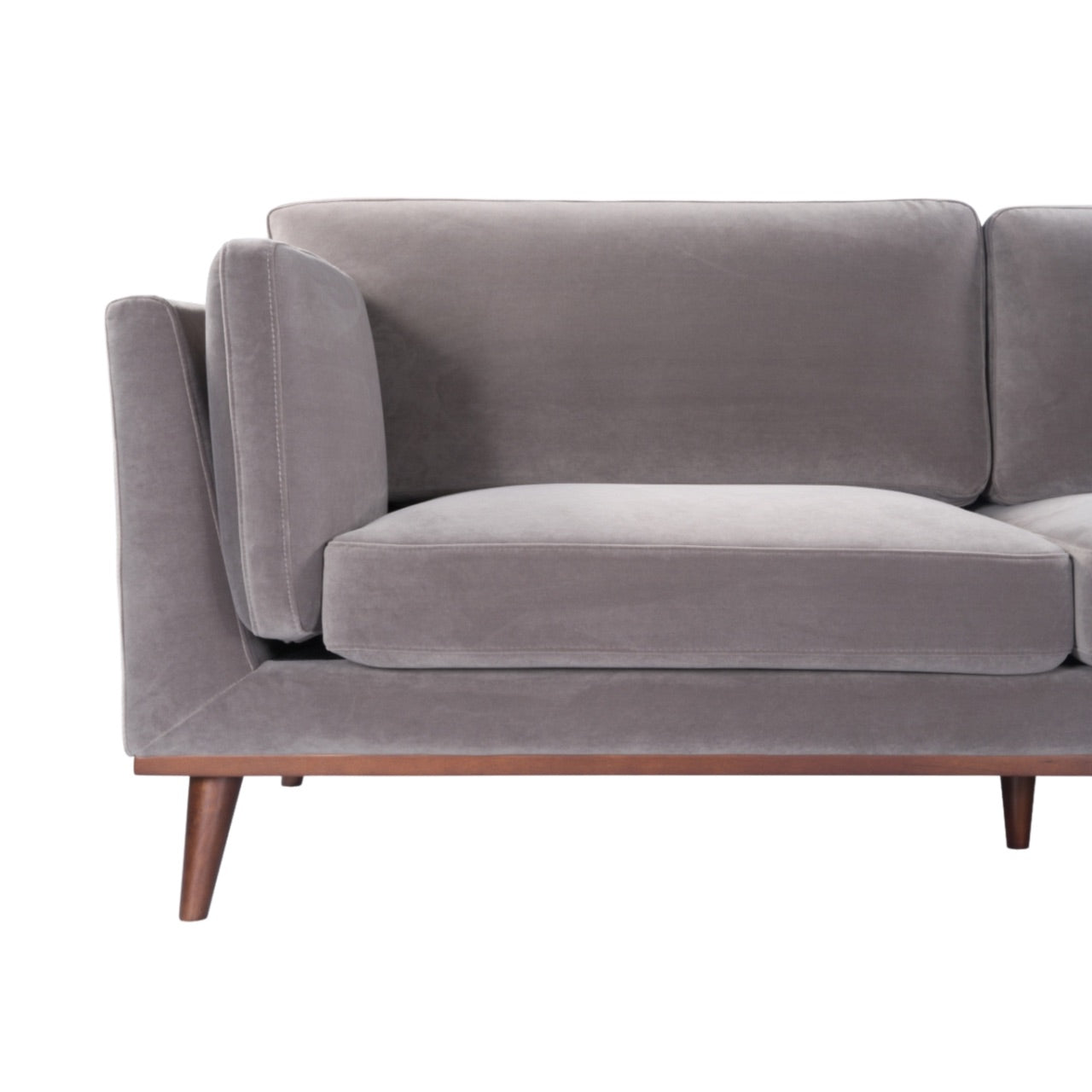 Shop the Mickey 3 Seat Sofa in a fashionable grey velvet hue with tapered walnut legs. This is a contemporary masterpiece. Shop online today at www.nobleandnook.co.uk