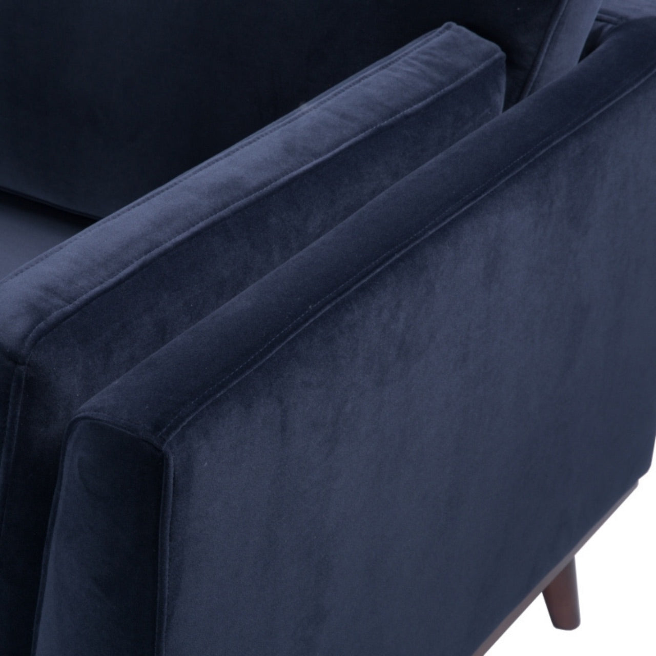 Shop the Mickey 2 seater sofa in Midnight Blue velvet with a walnut frame and tapered walnut legs, its a contemporary masterpiece. Shop online today at www.nobleandnook.co.uk