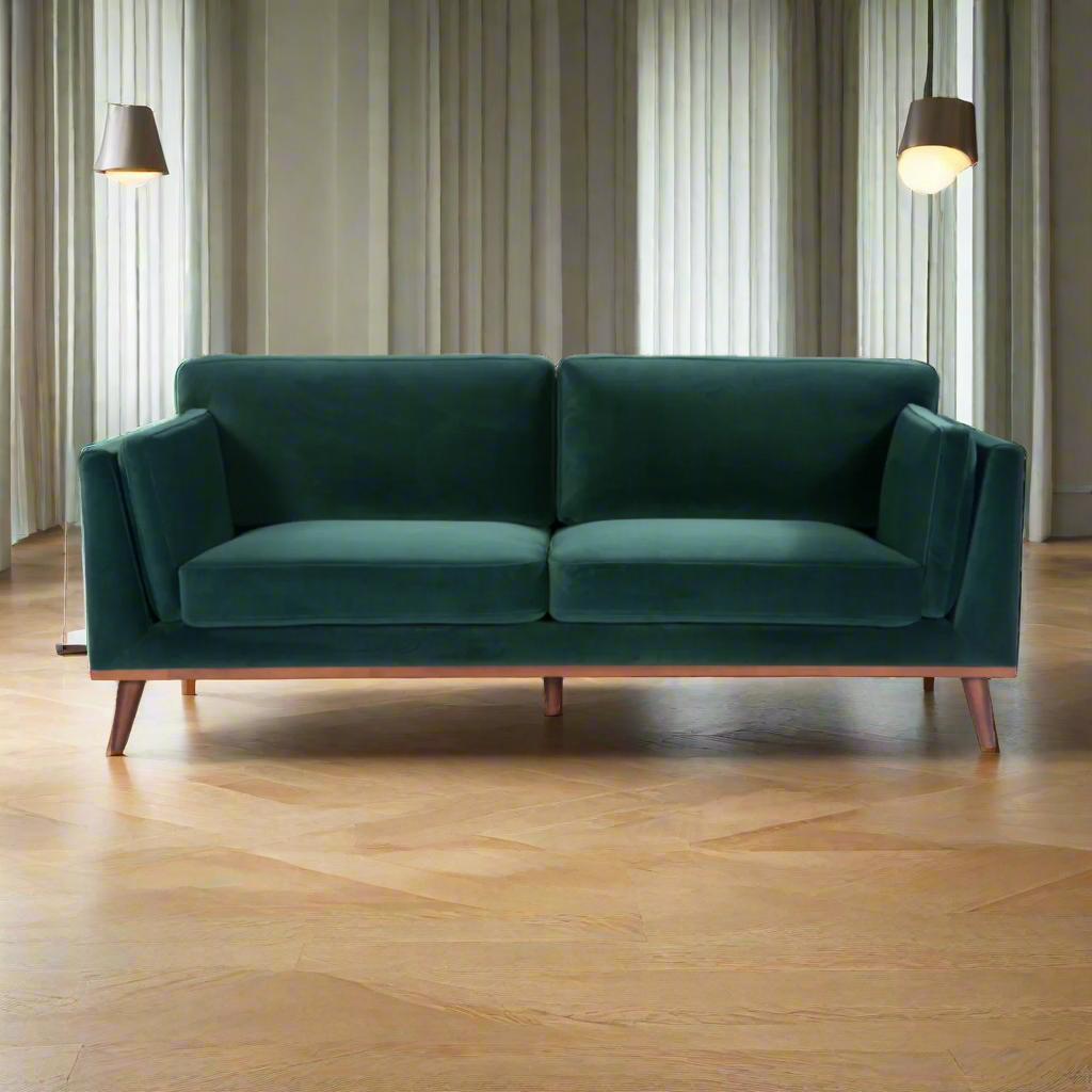 Shop the Mickey 3 Seat Sofa in a fashionable Emerald Green velvet with a walnut frame and tapered walnut legs. This is a contemporary masterpiece. Shop online today at www.nobleandnook.co.uk
