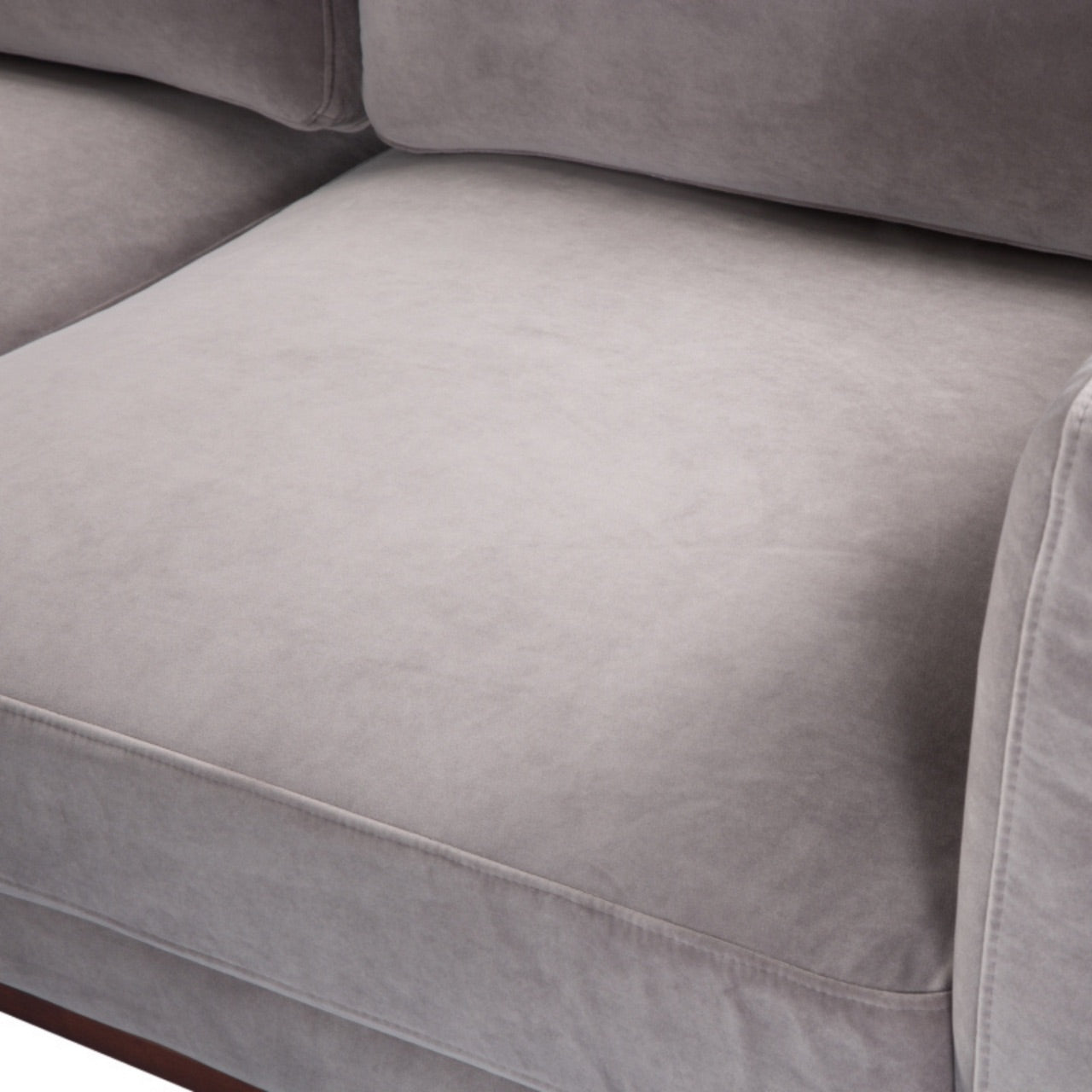 Shop the Mickey 3 Seat Sofa in a fashionable grey velvet hue with tapered walnut legs. This is a contemporary masterpiece. Shop online today at www.nobleandnook.co.uk