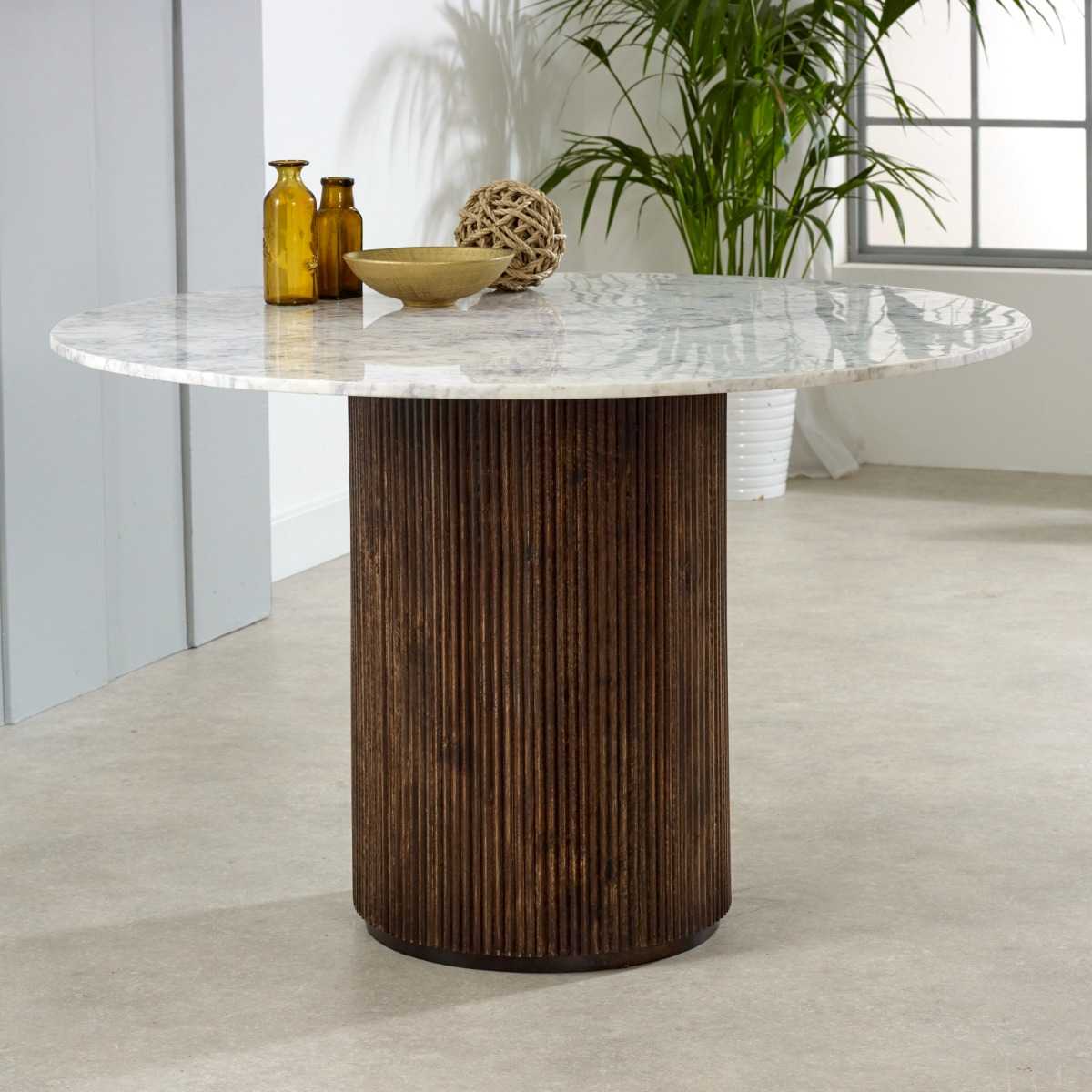 Luxurious white marble top with a sculptural base crafted from 100% solid mango wood for textural depth. Handmade in India using eco-friendly materials. H76×W120×D120cm. www.nobleandnook.co.uk