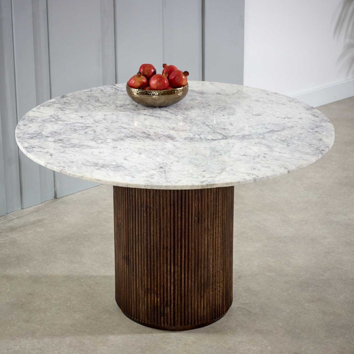 Luxurious white marble top with a sculptural base crafted from 100% solid mango wood for textural depth. Handmade in India using eco-friendly materials. H76×W120×D120cm. www.nobleandnook.co.uk