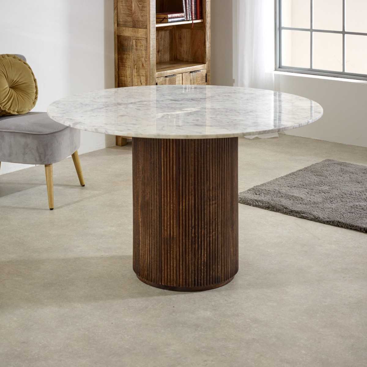 Luxurious white marble top with a sculptural base crafted from 100% solid mango wood for textural depth. Handmade in India using eco-friendly materials. H76×W120×D120cm. www.nobleandnook.co.uk
