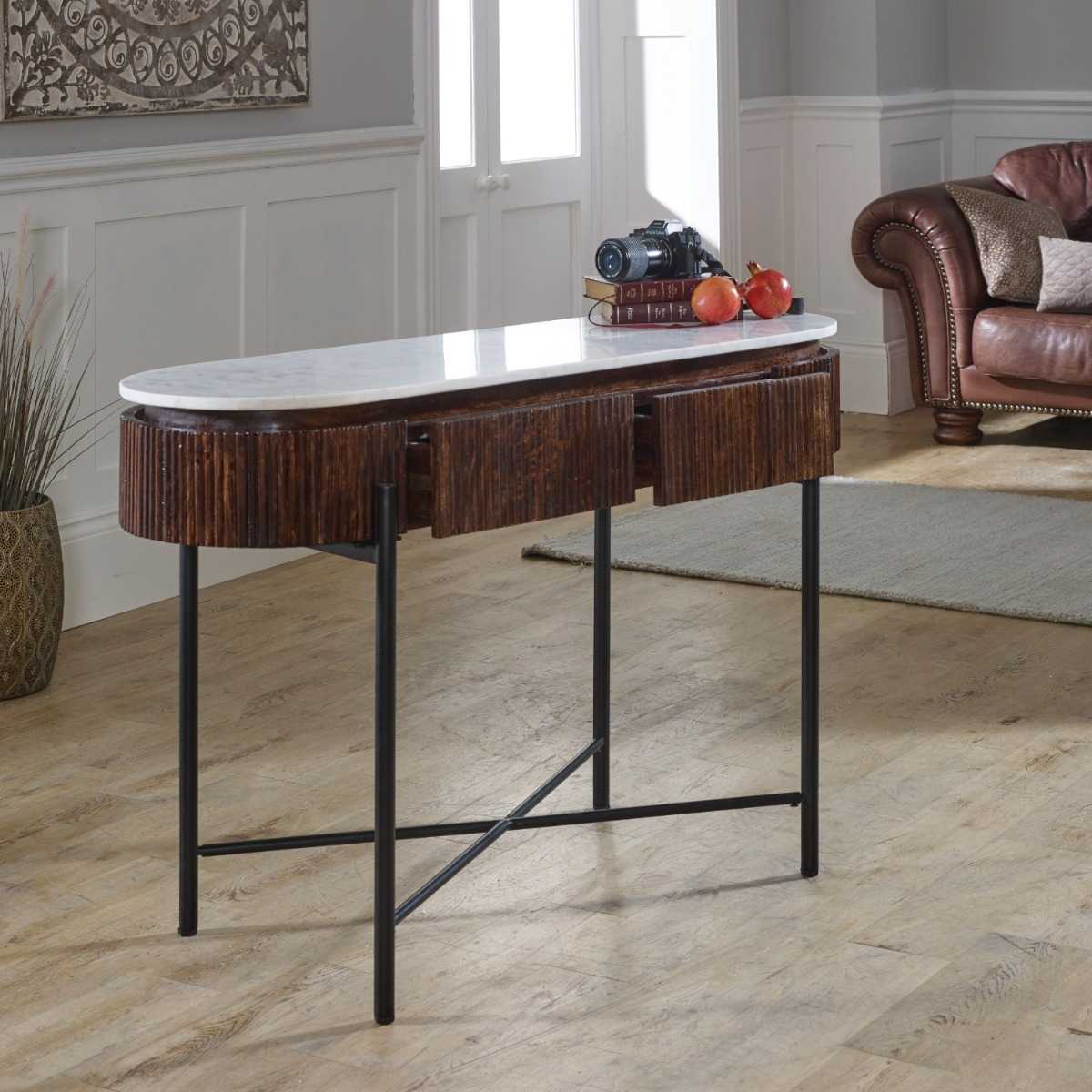 The handmade Opal Console Table with smooth marble top nests within a beautifully fluted mango wood frame, all supported by refined metal legs. H77×W120×D40 cm. Shop online today at www.nobleandnook.co.uk
