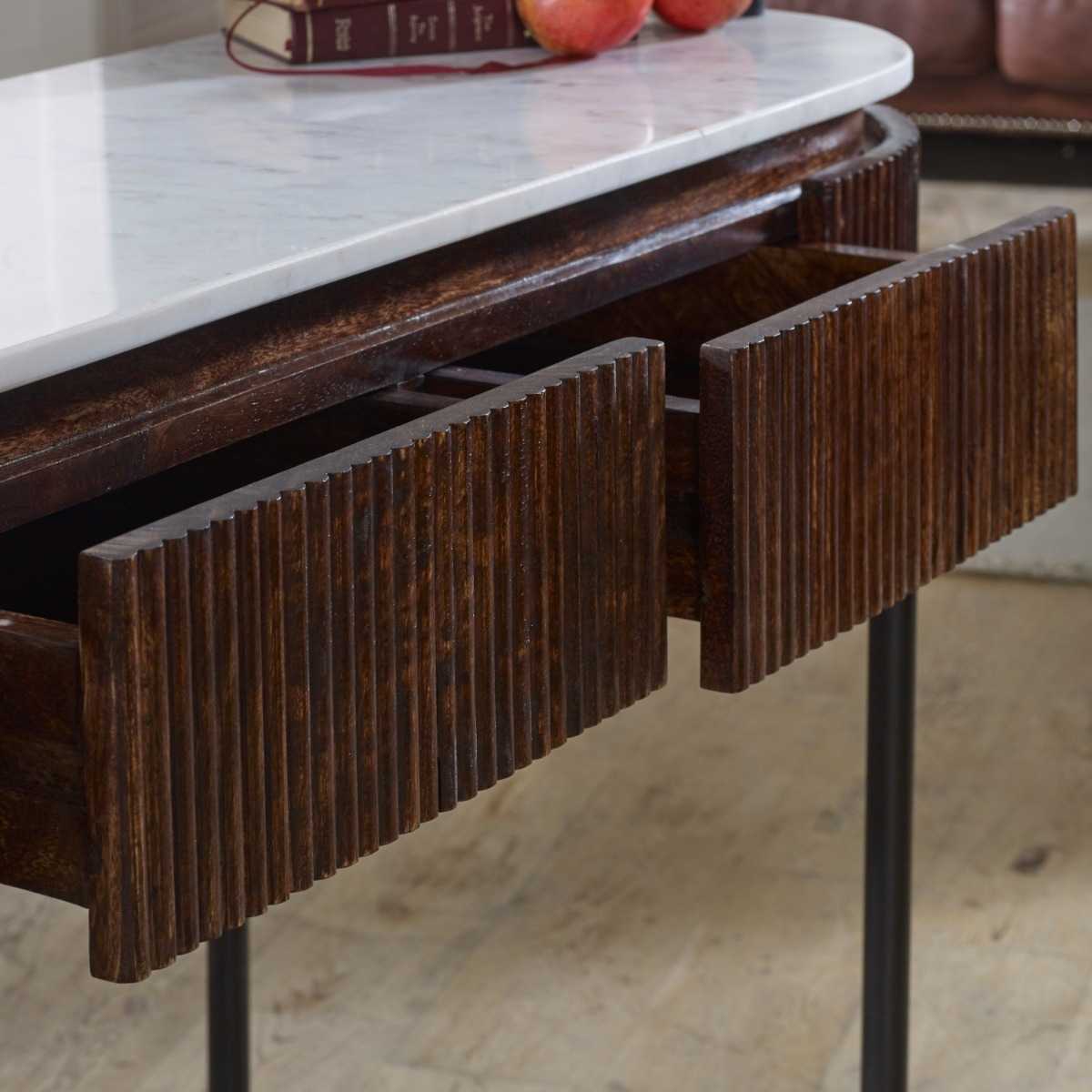 The handmade Opal Console Table with smooth marble top nests within a beautifully fluted mango wood frame, all supported by refined metal legs. H77×W120×D40 cm. Shop online today at www.nobleandnook.co.uk