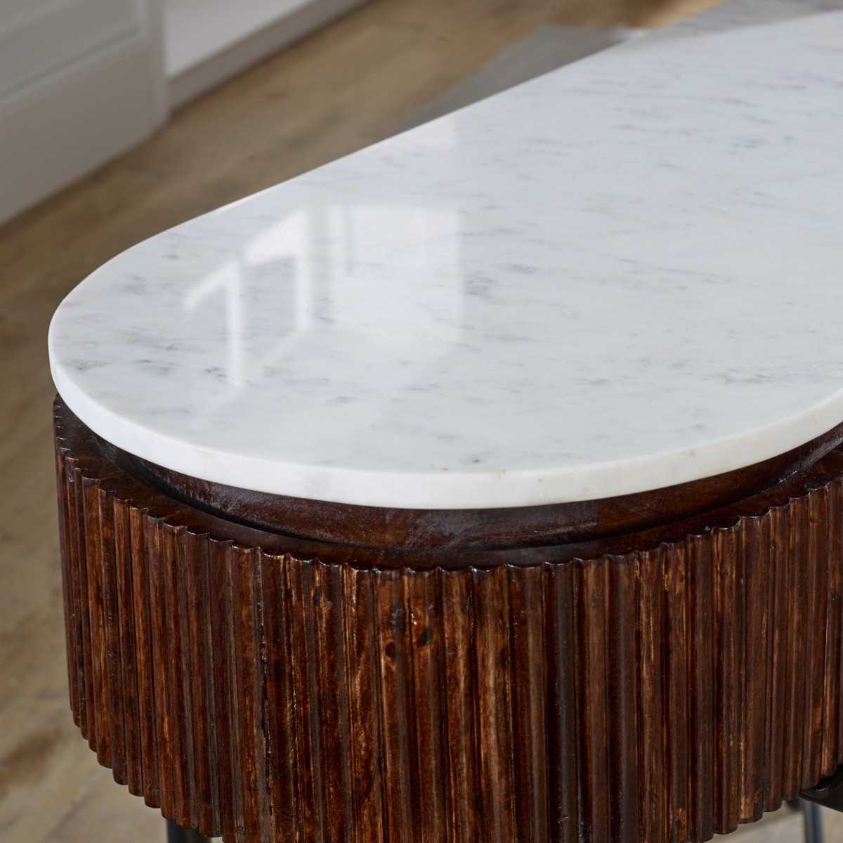 The handmade Opal Console Table with smooth marble top nests within a beautifully fluted mango wood frame, all supported by refined metal legs. H77×W120×D40 cm. Shop online today at www.nobleandnook.co.uk