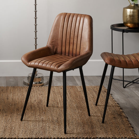 Upholstered in Vintage Brown Leather with ribbed back cushioning. Vintage style and modern functionality. A refined addition to any dining setting or living space. Available today at www.nobleandnook.co.uk