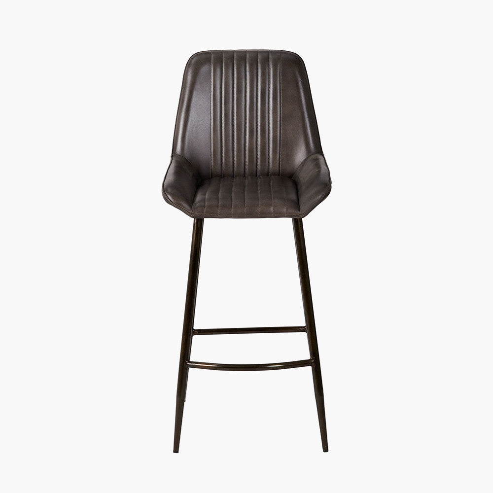 Upholstered in deep peppercorn-toned leather with ribbed cushioning and bronze metal frame, this handcrafted bar stool offers both comfort and visual impact. Shop online today at www.nobleandnook.co.uk