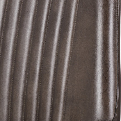 Upholstered in deep peppercorn-toned leather with ribbed cushioning and bronze metal frame, this handcrafted bar stool offers both comfort and visual impact. Shop online today at www.nobleandnook.co.uk